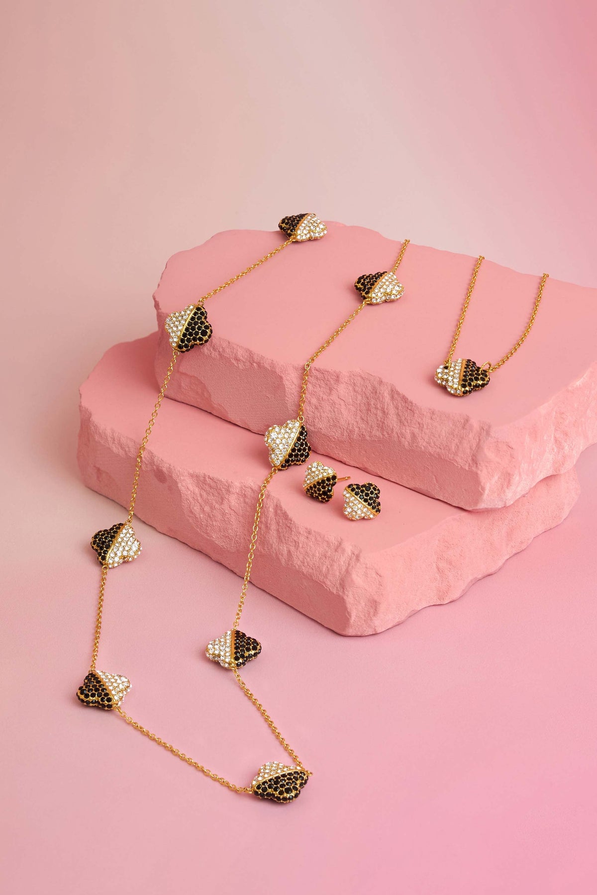 Rossi jewellery featuring the Carisma logo, displayed on pink blocks