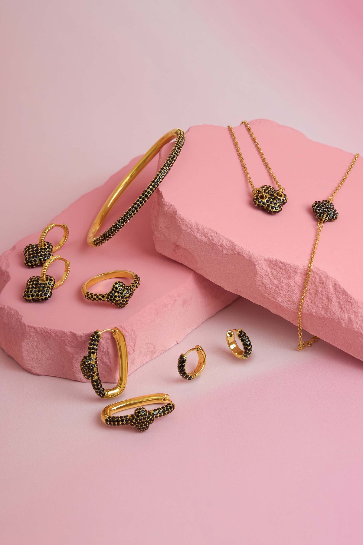 Rossi jewellery featuring the Carisma logo, displayed on pink blocks
