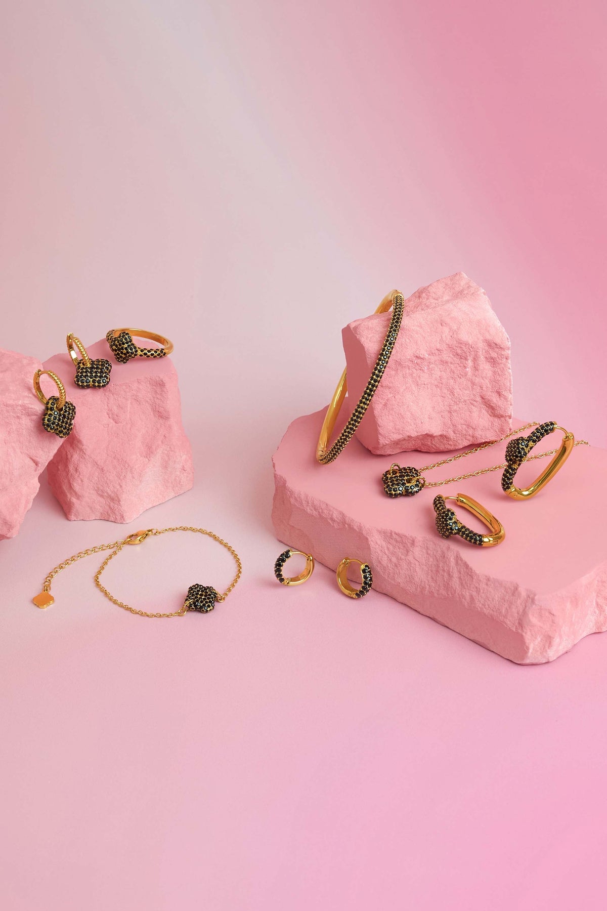 Rossi jewellery featuring the Carisma logo, displayed on pink blocks