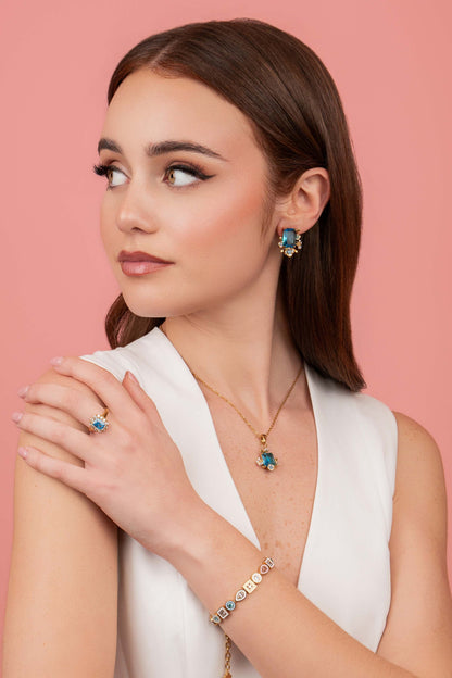 Model wearing Pimpernell Blu Reġina Necklace, Pimpernell Blu Reġina Stud Earring Set